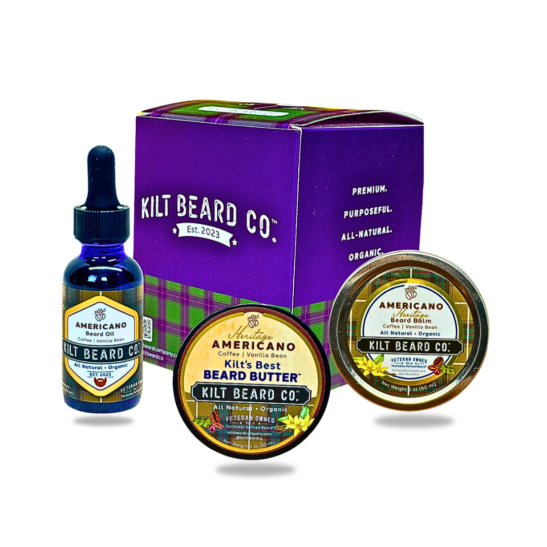 Kilt Beard Co. beard care set including a purple branded box, a blue dropper bottle of beard oil, a round tin of beard butter, and a smaller oval tin, all arranged on a white background. Americano scent profile of vanilla and coffee.