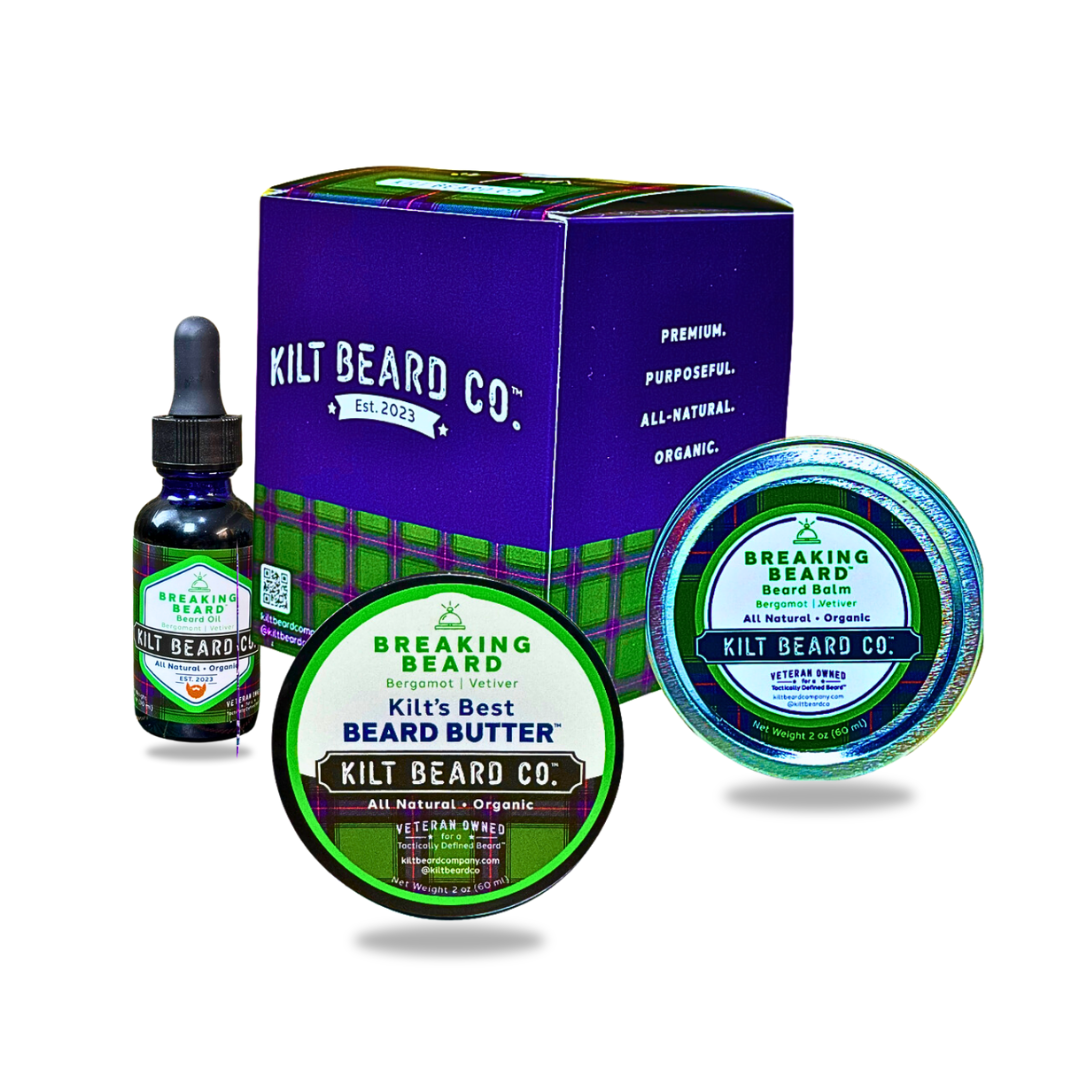 Kilt Beard Co. beard care set featuring a purple and green product box, a small dark dropper bottle, and two round containers of beard balm and beard butter with green and blue labels, shown on a white background. Scent profile: bergamot, juniper berry, copaiba.