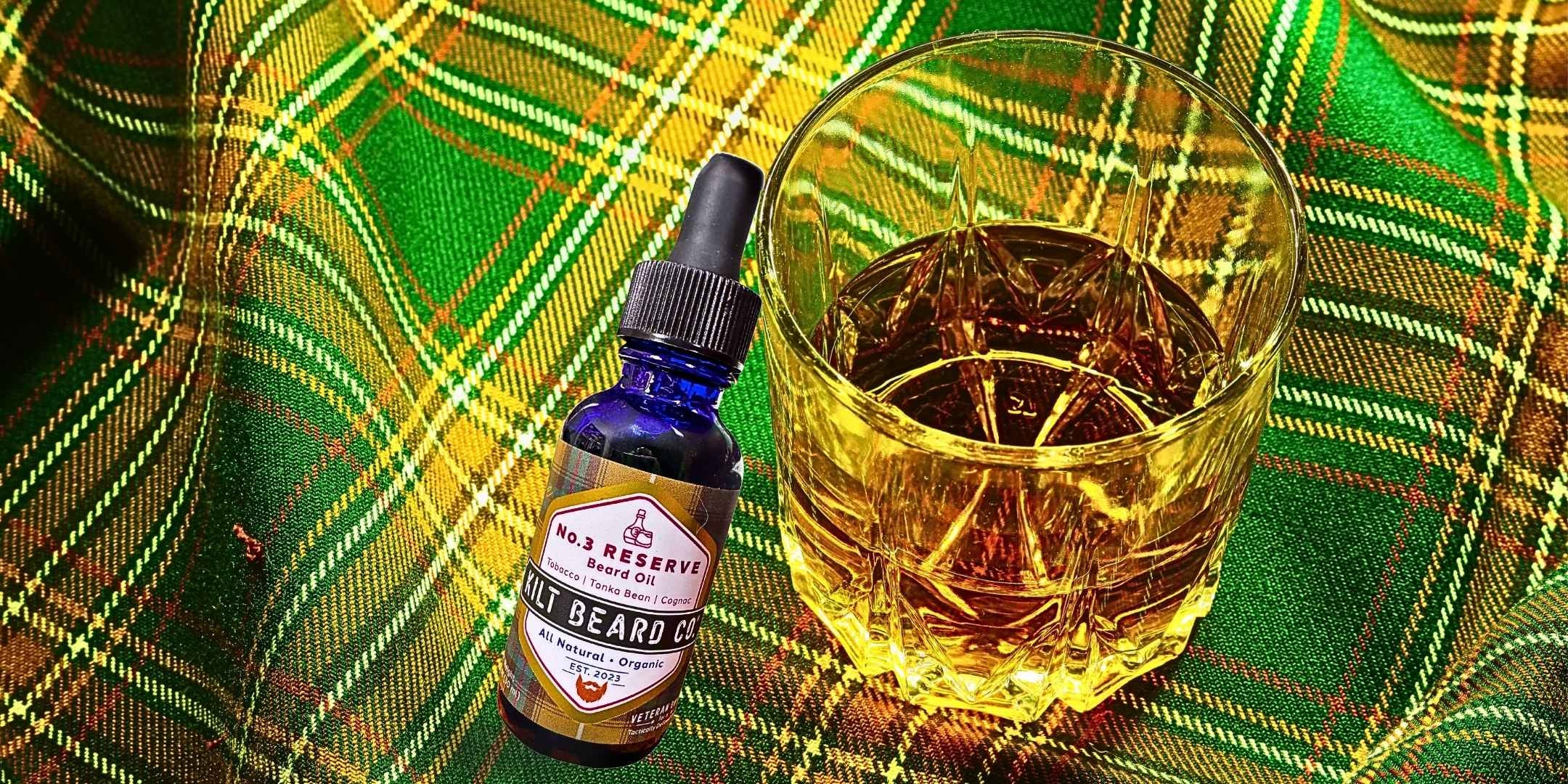 Kilt Beard Co. Beard Oil- No.3 Reserve on resting on a whiskey sipping glass with heritage tartan. 